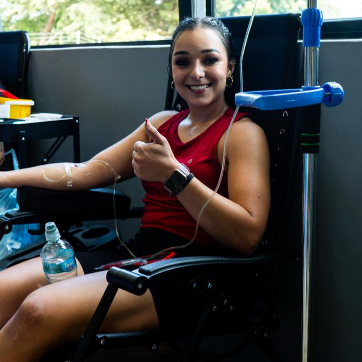 Woman receiving an intravenous treatment in a medical setting